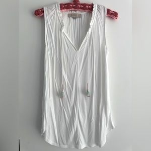Sleeveless white top with tassels